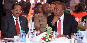 President Uhuru Kenyatta (right) and his Somalia counterpart Mohamed Abdullahi Farmaajo follow proceedings during Kenya's 16th annual National Prayer Breakfast at Safari Park hotel in Nairobi on May 31, 2018.