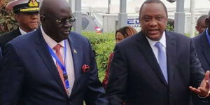 President Uhuru Kenyatta (right) speaks to Education CS George Magoha.