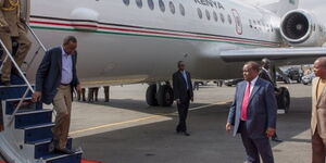 President Uhuru Kenyatta alighting from a plane.