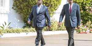 President Uhuru Kenyatta (Right) strolls at State House with Interior CS Fred Matiang'i during a past event.
