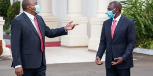President Uhuru Kenyatta and his deputy William Ruto share a light moment at State House Nairobi 