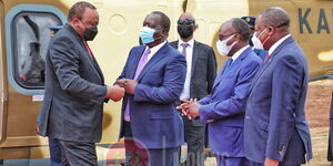 President Uhuru Kenyatta exchanges greetings with his cabinet secretaries, from left; Fred Matiang'i (Interior), James Macharia (Transport) and Mutahi Kagwe (Health) at Wanguru stadium in Kirinyaga County on Wednesday, October 20.