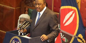 President Uhuru Kenyatta making an address in Parliameent, behind him is the Presidential Standard.