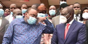 President Uhuru Kenyatta speaks to DP William Ruto outside KICC after PG meeting on Monday, June 22.