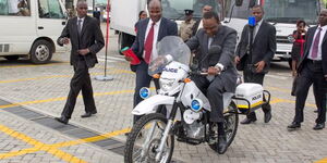 President Uhuru Kenyatta test-rides a police motorbike in Nairobi in July 2014.
