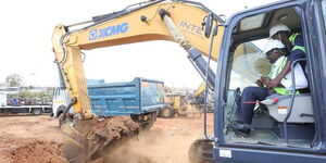 President William Ruto operates an excavator during the groundbreaking of the Kibera Soweto East Zone B Social Housing Project.