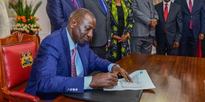 President William Ruto signing into law the Finance Act 2023 infront of other leaders at State House on June 26, 2023