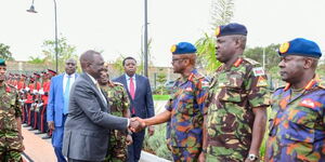 President William Ruto (left) greets KDF boss Francis Ogolla during a parade in Embakasi on April 19, 2023. 
