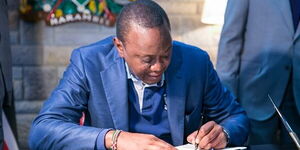 President Uhuru Kenyatta signs into law the Movable Property Security Rights Bill 2017, on May 10, 2017.