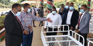 Principal Secretary Karanja Kibicho checking the first batch of the hospital beds procured by President Uhuru Kenyatta