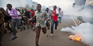 Protesters scamper for safety after teargas was fired at a past demonstration in Nairobi