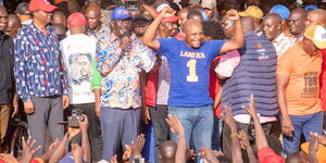Azimio leader Raila Odinga (holding microphone) and Phelix Odiwuor ( raising hands) address a rally at Undugu Grounds in Lang'ata, Nairobi County in June 2022. 