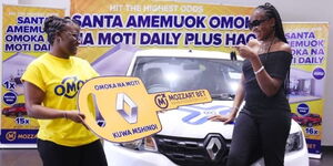 Rachael Kasongo Muyangu is presented with the keys for her Renault Kwid on Tuesday, December 14, after winning the Mozzart Bet Omoka na Moti promotion.