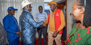 Raila Odinga greets Jubilee Secretary General Jeremiah Kioni moments after arriving to Kenya from South Africa on Monday, January 23