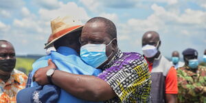 ODM leader Raila Odinga and Interior CS Fred Matiang'i embrace before a fundraiser in Mwongori High School in Kisii County on October 22, 2021.