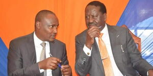 ODM Party leader Raila Odinga in a brief consultation with Treasury Cabinet nominee John Mbadi.