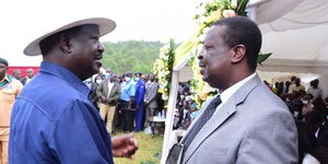 Former Prime Minister Raila Odinga condoles with ANC party leader Musalia Mudavadi at the burial of the latter's stepmother in Vihiga County on Saturday, December 18, 2021 