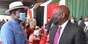 ODM leader Raila Odinga (left) converses with Deputy President William Ruto (right) during the Jamhuri Day celebrations at Uhuru Gardens, Nairobi County on Sunday, December 12, 2021