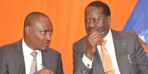Azimio leader Raila Odinga (right) and ODM party chairman John Mbadi hold discussions at a past event.
