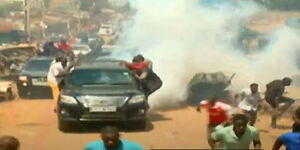 Police officers lob teargas on Azimio la Umoja leader Raila Odinga's convoy in Kawangware, Nairobi on Monday, March 27, 2023.