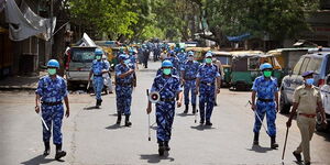 Rapid Action Force personnel patrol a street during the lockdown in India.