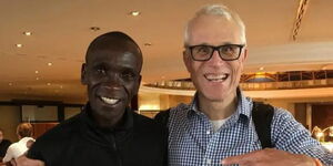 Record-breaking athlete Eliud Kipchoge and his helper Claus Schulke.
