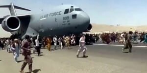 Residents cling on US plane on a runway in Kabul, Afghanistan.