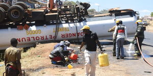 Residents siphon fuel from overturned tanker along Malaba - Eldoret Road.