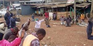 Boda boda operators and mechanics kneel in prayer for Coronavirus in Ruaka town on Saturday, March 21, 2020.