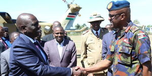 President William Ruto and General Francis Ogolla shaking hands during an event on October 14, 2022.