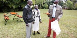 Deputy President William Ruto (Right) inspects a harvest of cassava and yams he received from Kamunyu Wambugu and Isabella Wanjiru on July 21, 2020