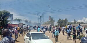 Police lob teargas to disperse a rowdy crowd in Kondele, Kisumu County during DP William Ruto tour on November 10, 2021.