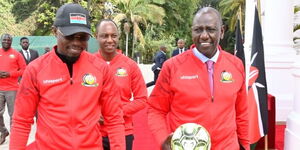 President William Ruto (right) unveils the East African Community Pamoja bid for the AFCON 2027 at State House on Monday, May 15, 2023. He is flanked by Sports CS Ababu Namwamba and PS Jonathan Mueke of the Ministry of Agriculture and Livestock Development.