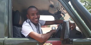 Samuel Muchoki alias Samidoh driving a police car