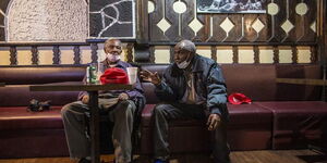 Samuel Ndesanjo Nyaga (right) and his roommate Josiah Kamano Gashoka at a restaurant in Canada.