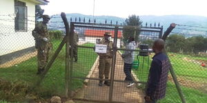 Uganda People's Defence Force (UPDF) and police officers seal an entrance to the Kabale referral hospital in Rwanda.