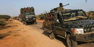 Trucks carrying Somalia troops with guns.