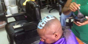 Nairobi Governor Mike Sonko's long-time barber pictured serving him at her shop in Buru Buru, Nairobi in February 2016