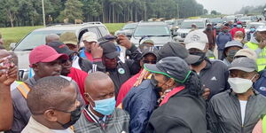 Sports CS Amina Mohammed (in green stripe cape) hugs CS Raphael Tuju during the walk from Karen to Kijabe Hospital on Sunday, June 20, 2021.