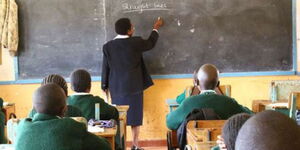 A photo of a teacher and students during an ongoing class session. 