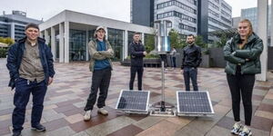 Students standing next to the flatpack wind turbine.