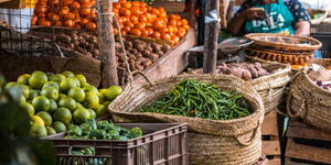 Undated image of a lady selling vegetables at a local fresh produce market.