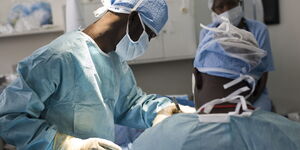 Surgeons performing surgery on a patient.