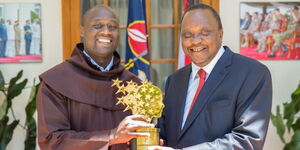 Teacher Peter Tabichi Poses for a photo with President Uhuru Kenyatta.
