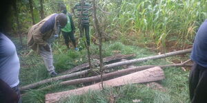 Residents look into a pit in Chuka, Tharaka Nithi where a man was rescued after 13 days on June 3, 2020