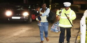 The female officer helping out a mother during the enforcement of the dusk to dawn curfew on March 28, 2020.