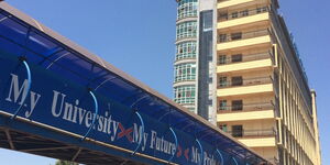 The footbridge at Mount Kenya University main campus and a tower in the background.
