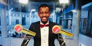 Timothy Otieno Poses for a Photo With His Awards.