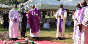 Priests say their final prayers as Tony Waswa's body is lowered to the ground. May 20, 2020.