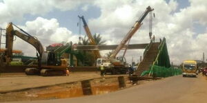 Tractors demolish a footbridge along Waiyaki Way.